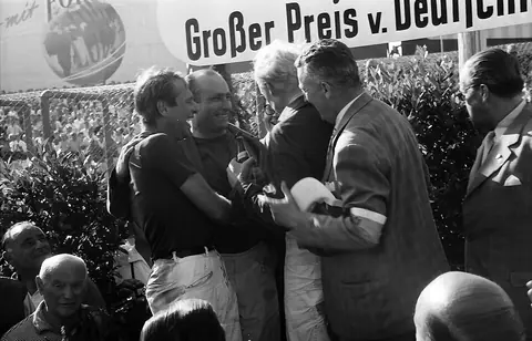 Mike Hawthorn (fair hair) with Juan Manuel Fangio and Peter Collins after the 1957 German Grand Prix